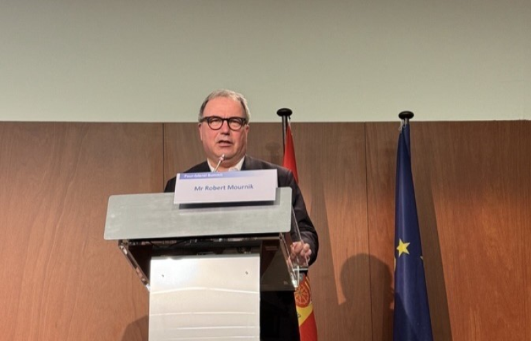 The image shows BEREC Chair Robert Mourik (ComReg, Ireland) during his speech at the 4-Lateral Summit 2025.