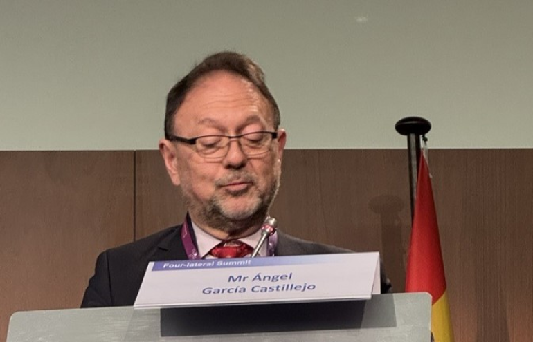 The image shows Angel Garcia Castillejo during his speech at the 4-Lateral Summit 2025.