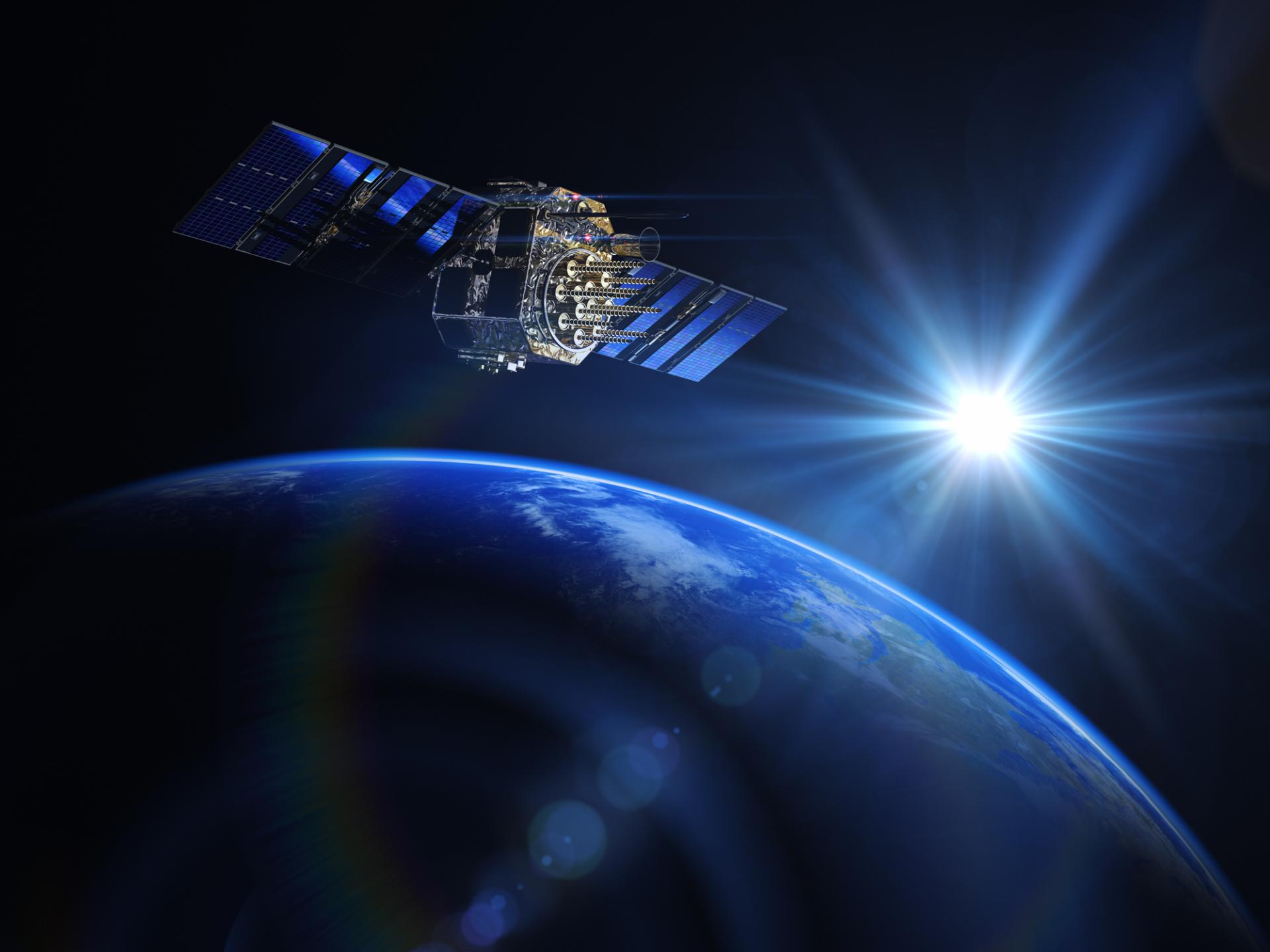 The image shows a satellite in the atmosphere with the earth in the background.