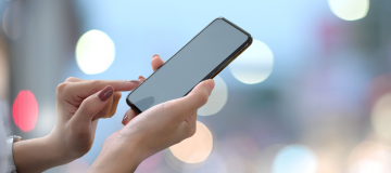 The image shows a woman using a mobile phone