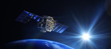 The image shows a satellite in the atmosphere with the earth in the background.