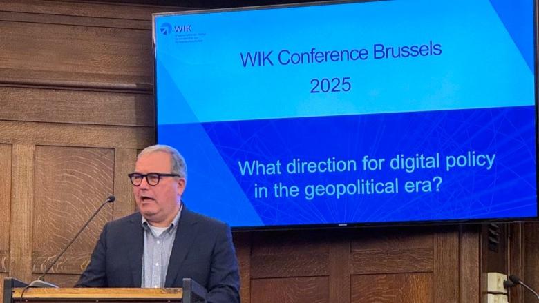 The image shows BEREC Chair Robert Mourik (ComReg, Ireland) during his keynote at the WIK Conference 2025.