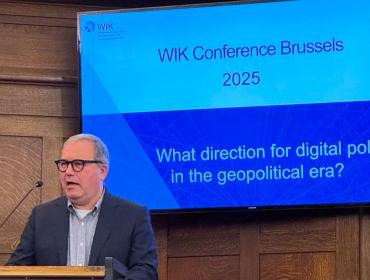 The image shows BEREC Chair Robert Mourik (ComReg, Ireland) during his keynote at the WIK Conference 2025.