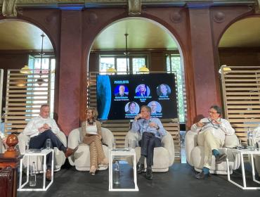 The image shows incoming BEREC Chair 2027 Alejandra de Iturriaga Gandini (CNMC, Spain) during the panel at Cullen's 40th anniversary conference.